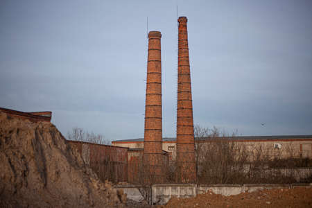 Brick factory. The old factory. Industrial landscape. Brick pipes. Industrial processing area. Environmental pollution. Entirely red building.の写真素材