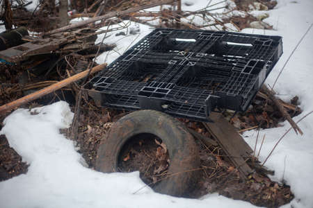 Discarded tire in nature. Unauthorized landfill. Automotive pollution. Ecological harm. Tire tread.の写真素材