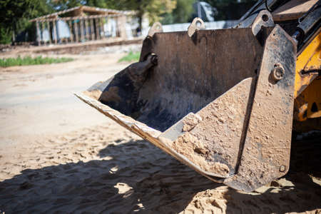 Tractor bucket. Construction machinery. Tool for raising soil. Machine at a construction site.の写真素材
