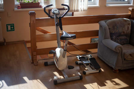 Exercise bike in the house. Sports at home. Active lifestyle with exercise machine for leg muscles. A special device for training the body. Bike without wheels.の写真素材