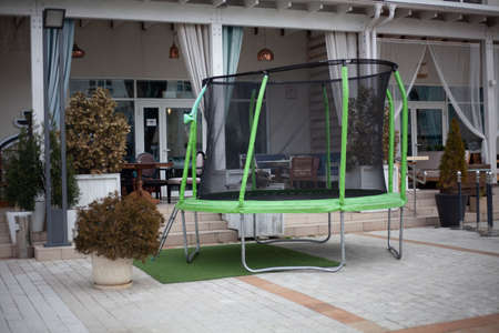 Trampoline for jumping in the yard. Sports Equipment. Entertainment for children. Trampoline assembled.の写真素材