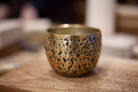 A metal bowl with a beautiful engraving. Vintage item in the workshop. A beautiful container for storing jewelry.の写真素材