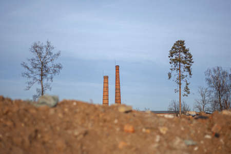 Brick factory. The old factory. Industrial landscape. Brick pipes. Industrial processing area. Environmental pollution. Entirely red building.の写真素材
