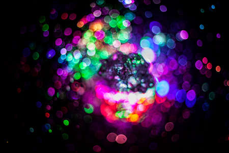 Splashes of water of different colors. Colored texture on a dark background. Fantana LED lighting. Transfusion of bright colors in water.の写真素材