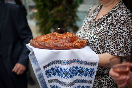 Bread with salt is a tradition of the Slavic peoples. Wedding ceremony in Russian. Baked loaf of bread. A treat for the bride and groom from their parents.の写真素材
