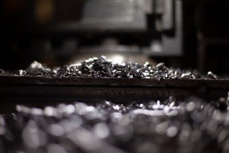 Metal shavings on the table. Repair in the workshop. Workplace after drilling metal.