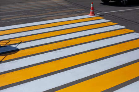 Painting the pedestrian zone. Pedestrian crossing over the highway. The markings on the road. Warning strips.の写真素材