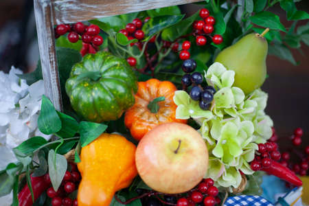 Autumn harvest. Pumpkin and other vegetables and berries from the garden. Still life of healthy food. Natural food.の写真素材