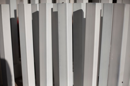 White painted metal profile. Steel product. Ready-made racks for the structure.