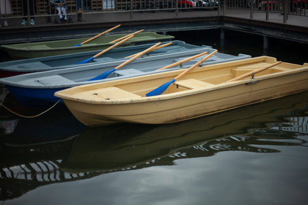 Boats at the pier. Pleasure boats for swimming on the lake. Lifeboats on the beach. Floating device...