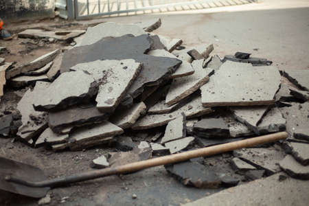 Removal of asphalt. Road surface repair. Working with a jackhammer. The road repair crew broke the asphalt.の写真素材