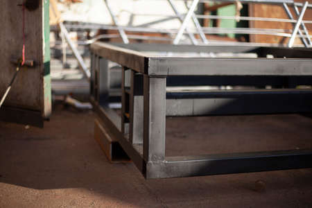 The metal structure lies on the street. Preparing a large advertising stand. Steel part welded from a metal profile.の写真素材