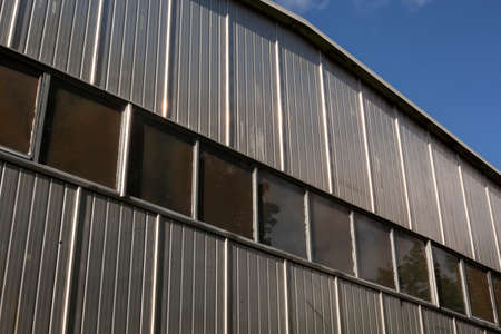Equipment storage hangar. Industrial temporary building. Metal building. Factory design. Warehouse space.の写真素材