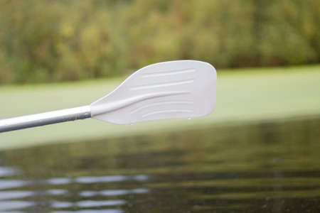 Paddle over the surface of the water. Swimming means. Boat trip on the lake.の写真素材