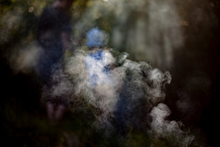Smoke in natural light. Puffs of smoke over the barbecue. Smoke texture in sunlight.