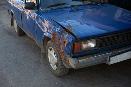 Rusty car. Old transport. Vehicle for transportation. The front of the car collapsed from time to time. The metal has rotted away.の写真素材
