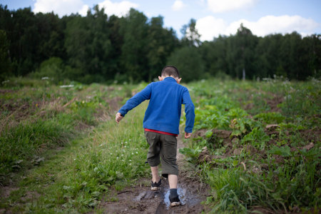 The child goes to no one knows where. Lost boy. The schoolboy walks in nature. The boy shot from the...