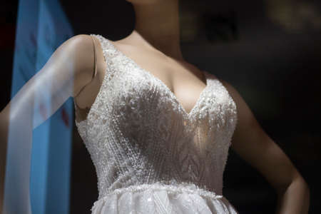 White dress on a mannequin. Lightweight fabric on a female mannequin to showcase outfits. Show of a wedding dress on a human figure.の写真素材