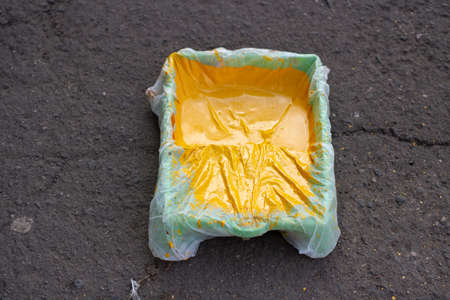 Pollen in a puddle. Beautiful stains in the water. Brownian motion of particles in a liquid. Spring pollen is yellow.の写真素材