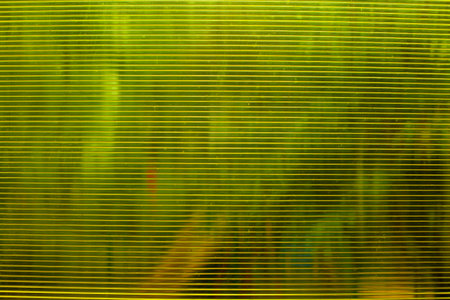 Corrugated plastic texture. Plastic transparent yellow surface.の写真素材