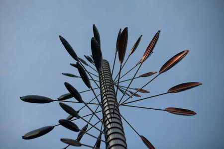 Wind-catching design. A sculpture in the park interacting with the wind. Wind turbine to determine the direction of the wind. Windy weather causes the structure to move in the park.の写真素材
