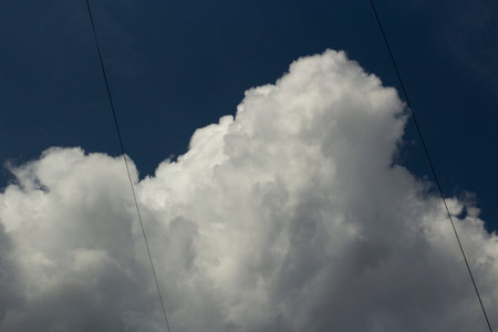 Clouds in the sky. White cumulus cloud close up. Summer weather in the sky.