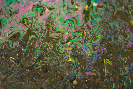 Gasoline on the asphalt. The texture of the fuel spilled on the road. Gasoline shimmers in all colors.の写真素材