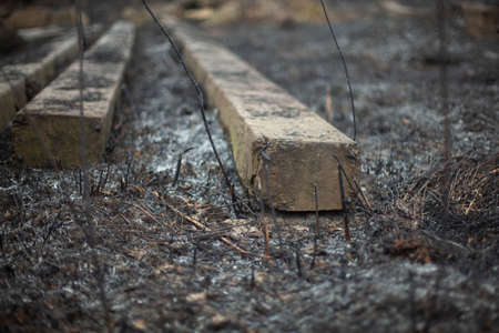 Concrete beams on the ground. Build materials after a fire. Remains on the scorched earth. Concrete blocks.の写真素材