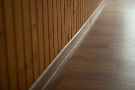 Skirting board in the room. The joint between the wall and the floor. The interior is in detail. Overhead materials for decorating walls and floors.の写真素材