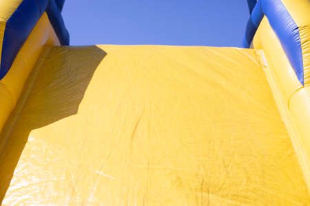 Inflatable obstacle course for fun. Inflatable structure in the park. A place for the joy of children. Playground. Butut is yellow-blue.の写真素材