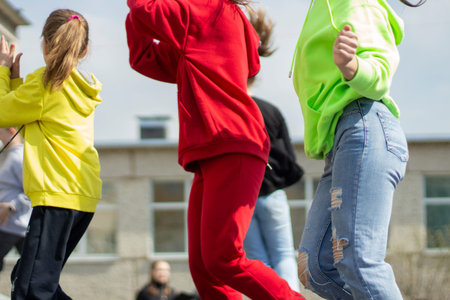 Children are dancing in the street. Many children dance to the music in the city. Schoolchildren perform at a dance lesson.の写真素材
