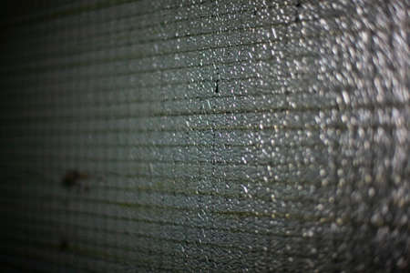 Dirty hall glass. Gloomy glass with metal wire. Safety glass.の写真素材