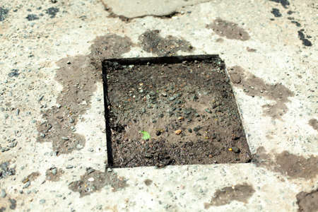 Road repair. Removing holes in the road. A cut piece of asphalt. Fragment of the track being repaired. Highway patching.の写真素材