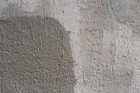 Gray wall. Gray painted wall. Rough concrete wall in different shades of gray. Simple background.の写真素材