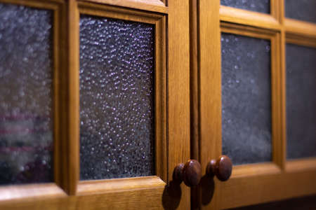Cabinet in the kitchen. Kitchen cabinet glass doors. Furniture in the kitchen. Old style of grandma's kitchen.の写真素材