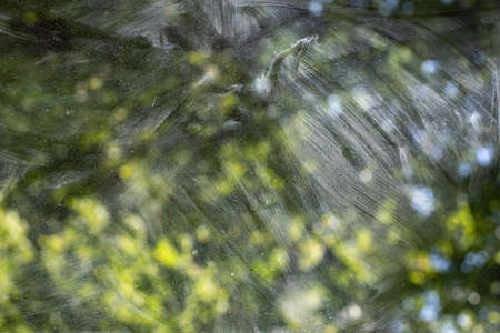 Dirty glass. Washing the window. The transparent glass is covered with dust. Light on a dirty window.の写真素材