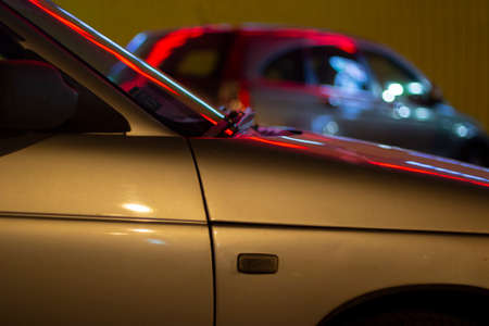 Cars at night in the lights from advertising. Car body details. Overnight parking for transport.の写真素材