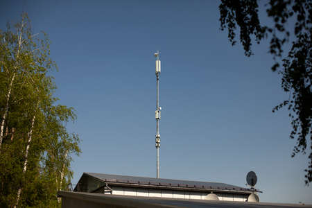 Roof with antenna for signal transmission. An antenna for broadcasting the Internet is installed on the roof of the building. Cellular transmitter.の写真素材