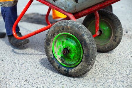 Trolley with asphalt. Road repair. Construction waste trolley. Repair work on the road.