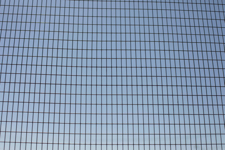 The grid in the stadium. The mesh structure. A metal surface made of wire.