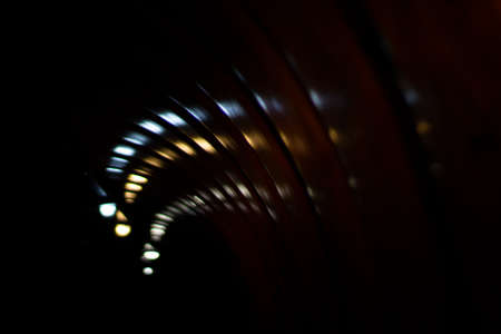 Glare of lights in the tunnel. The lights are twisting in a spiral. Reflection of light in a plastic tunnel.の写真素材