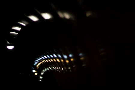 Glare of lights in the tunnel. The lights are twisting in a spiral. Reflection of light in a plastic tunnel.の写真素材