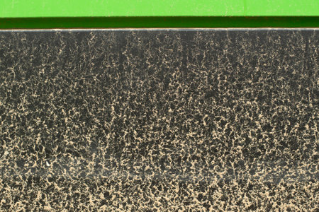 Dirty black surface. Sprays of dust on the wall. A dirty wall on the street.の写真素材