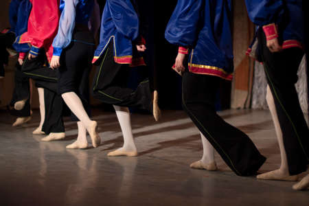 Children perform with dance on stage. Dance lessons. A lot of kids in the same clothes.の写真素材