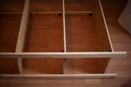 A wooden bookcase. Furniture with their own hands from the boards. The wooden structure in the apartment. Raw furniture.の写真素材