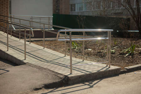 Handrails for people with limited mobility. Wheelchair access. Special handrails for people. Barrier-free environment at the entrance to the building.の写真素材