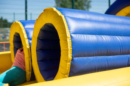 Inflatable tube. Rest obstacle course. Inflatable structure for fun. Children's playground for competitions.の写真素材