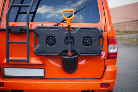 Rescue vehicle. Orange help machine with special equipment. Engineer's shoulder blade on transport. Mountain transport. Rescue service in the mountains.の写真素材