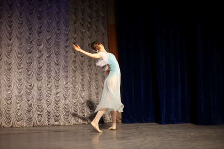 Ballerina on stage. Professional dance. The girl is dancing classical ballet. The graceful movement of a thin girl.の写真素材