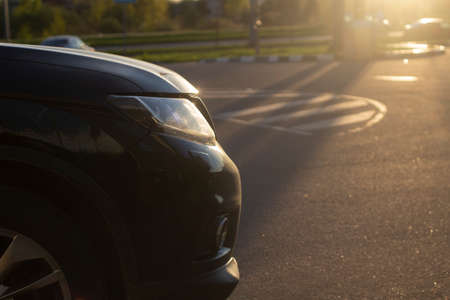 The headlight of the car on the street. Transport on the road. The car is in the sunlight.の写真素材